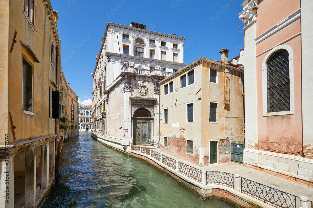 Venice, nobody in the canal and in the street, ancient buildings in a sunny summer day in Italy