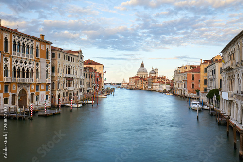 Venice, Grand Canal at dusk, cloudy sky in summer with Saint Mary of Health basilica in Italy