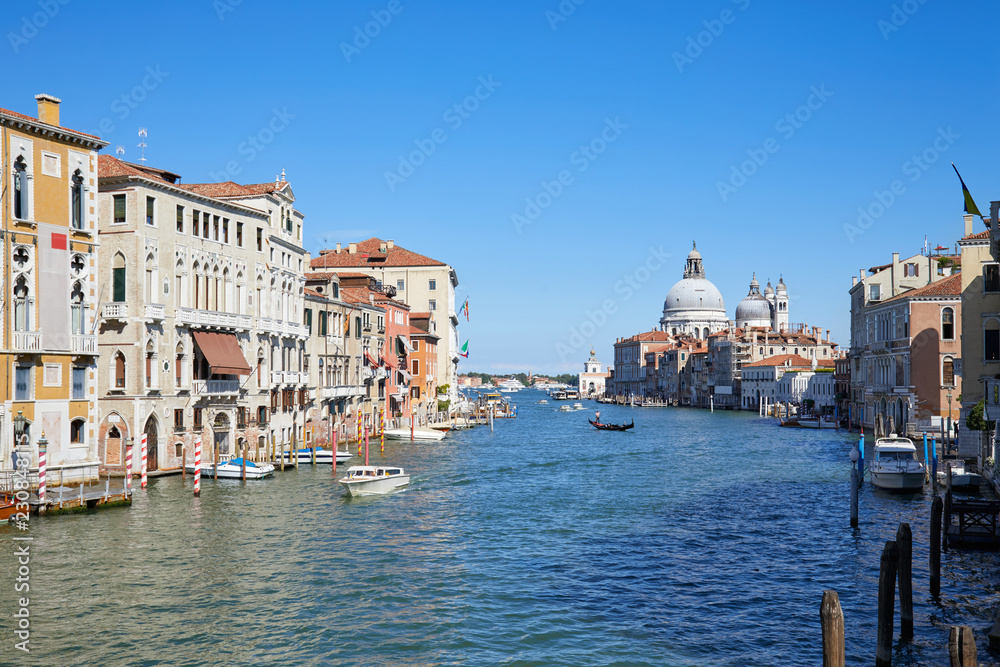 Grand Canal in Venice wide angle view with Saint Mary of Health basilica in Italy, clear blue sky