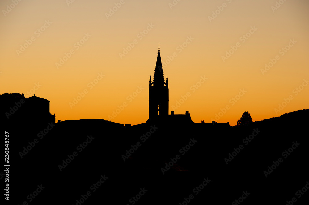 Beautiful sunrise on the steeple of the church and village of Saint Emilion, Religion, Gironde