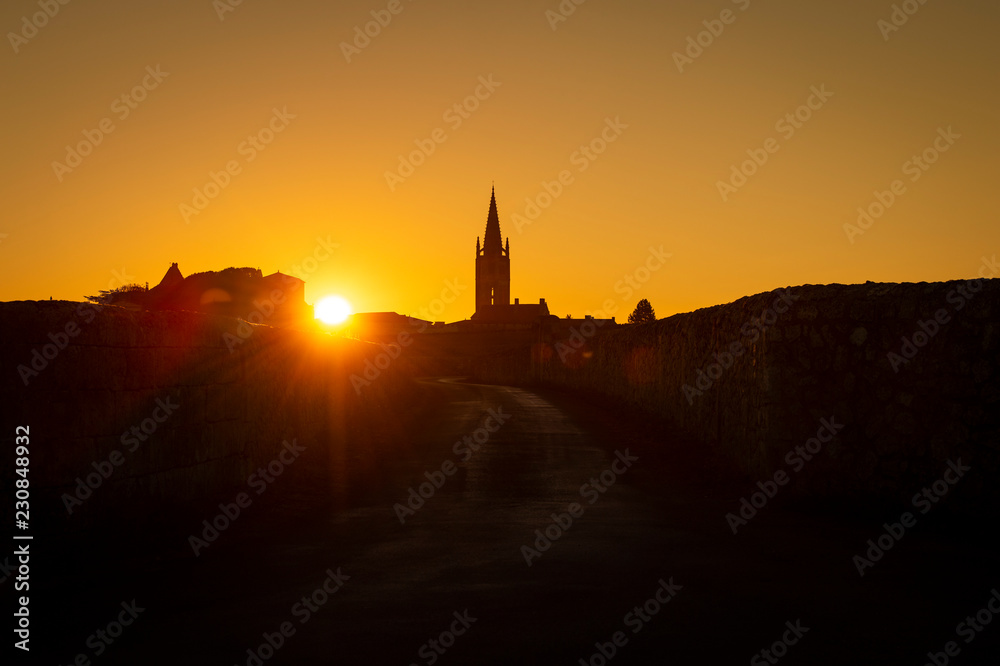 Beautiful sunrise on the steeple of the church and village of Saint Emilion, Religion, Gironde
