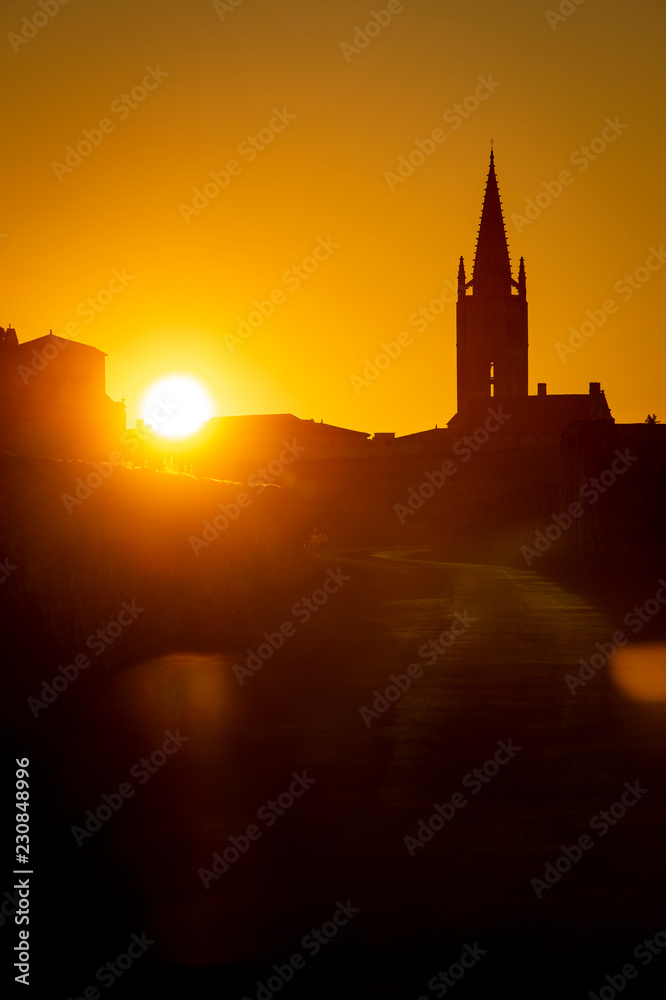 Beautiful sunrise on the steeple of the church and village of Saint Emilion, Religion, Gironde