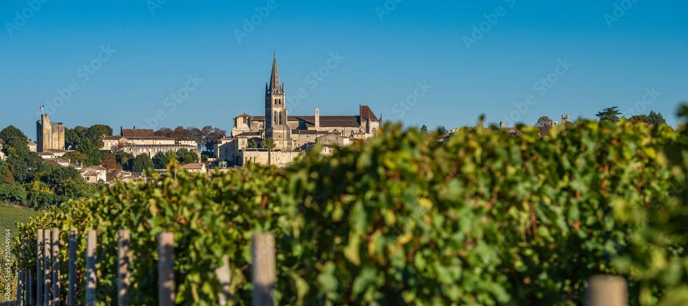Fototapeta premium Beautiful sunrise on the steeple of the church and village of Saint Emilion, Religion, Gironde