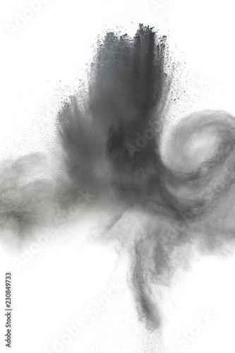 Black particles splatter on white background. Black powder dust exploding.