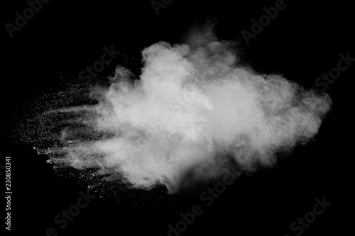 Bizarre forms of white powder explosion cloud against black background.White dust particles splash.