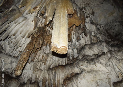 Big Azishskaya Cave in Adygea, Russia. Broken stalactite in section. photo