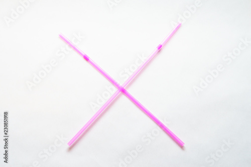 The plastic straw ban: a cross of two pink straws.