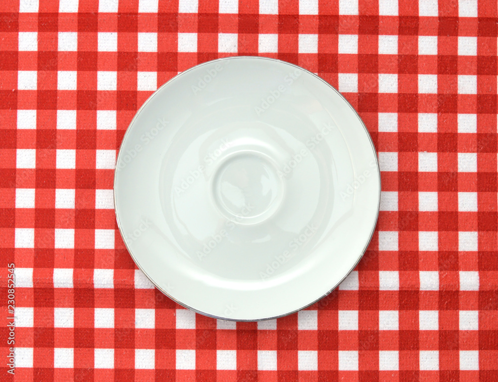 Empty plate at classic checkered tablecloth Empty plate at classic checkered tablecloth