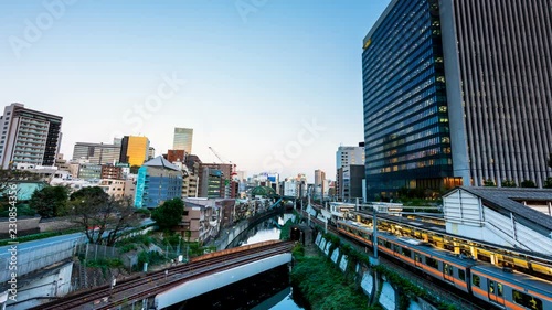 Time Lapse Video Day to Night The view from the Hijiribashi Bridge, a rail crossing of the Kanda River.Jr train and Tokyo Subway, and passengers who are waiting for a train at Ochanomizu station