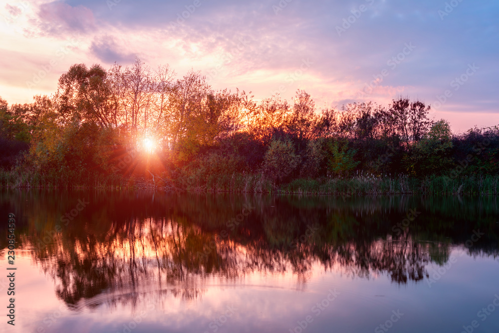 Obraz premium Amazing sunset on the lake, colorful landscape with sky and reflection in the water