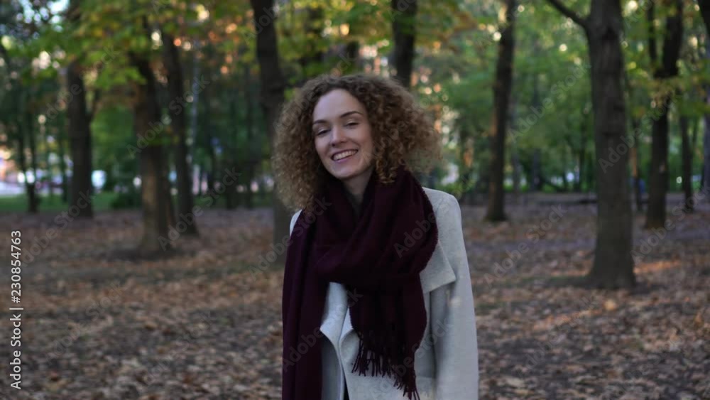 Young woman in autumn park throws up yellow leaves. Young woman in autumn park throws up yellow leaves.