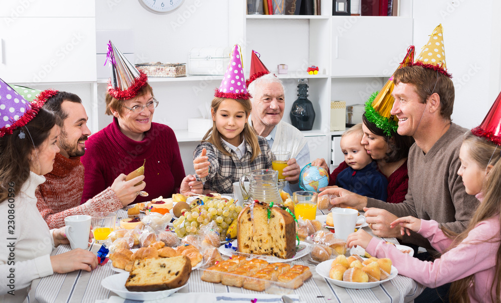 family proposing festive toasts during Christmas dinner