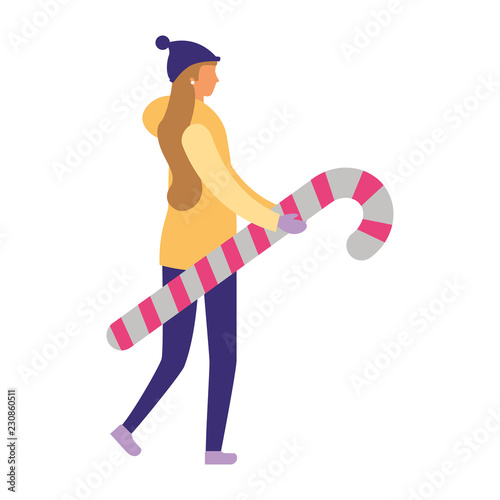 woman in winter clothes holding candy cane