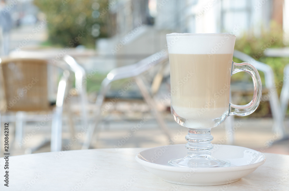 Transparent glass with latte or cappuccino.
