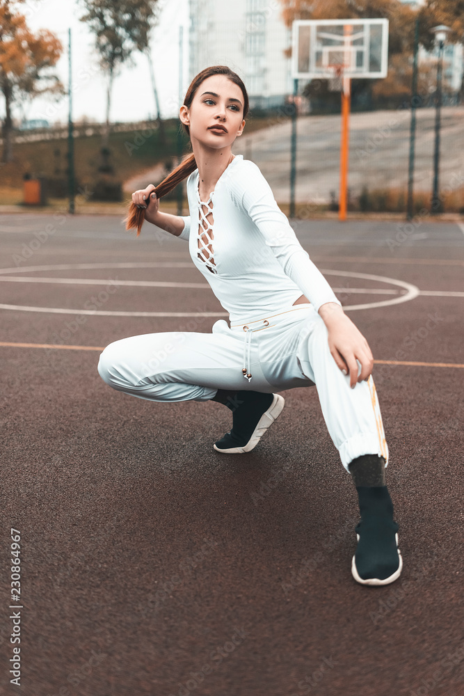 Fitness sport girl in fashion sportswear doing yoga fitness exercise in the  street, outdoor sports, urban style Stock Photo | Adobe Stock