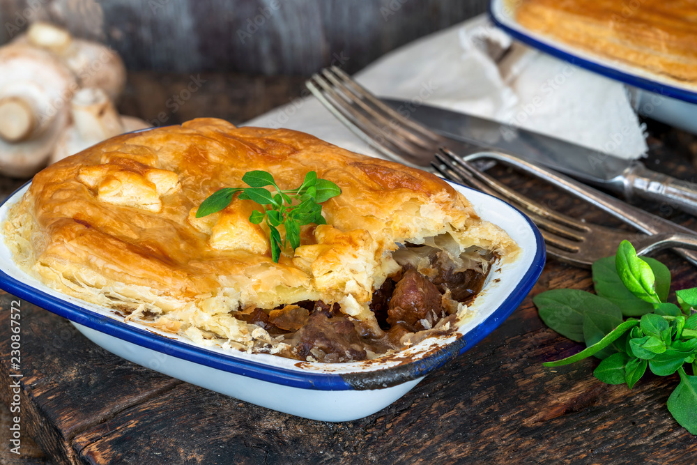 Steak and mushroom pie on rustic wooden backgournd