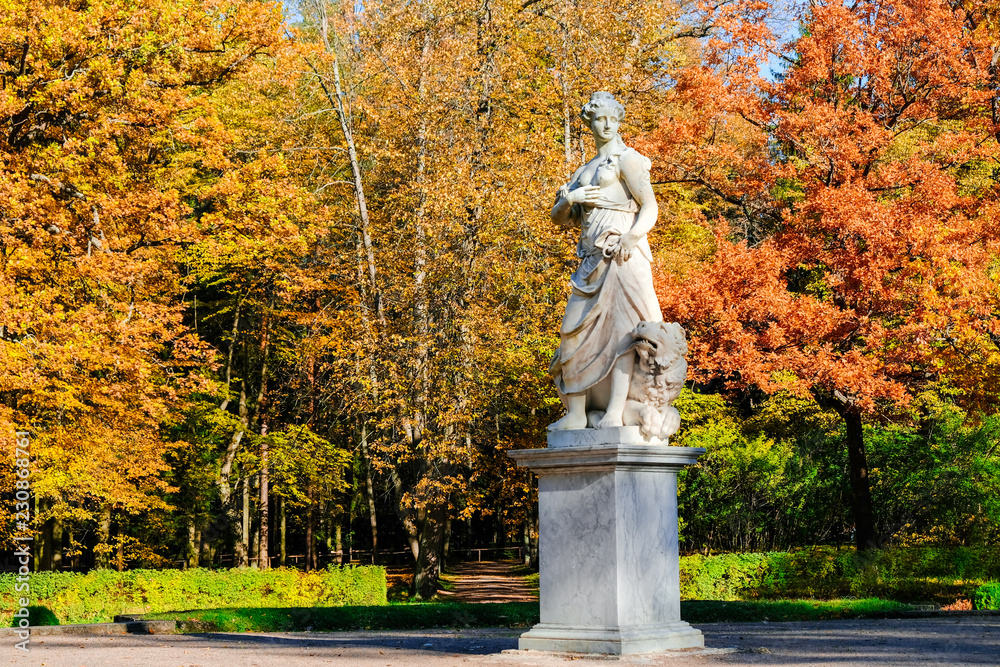 Beautiful autumn landscape in Pavlovsk park with the allegory sculpture Peace with a lion at his feet, Pavlovsk, Saint Petersburg.