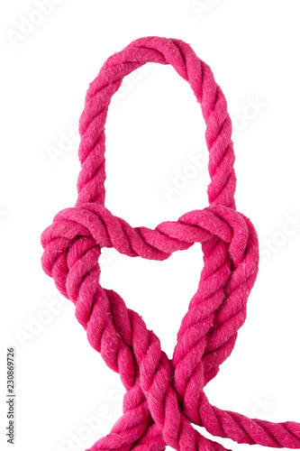Rope isolated on white. Close-up of node or knot from two pink ropes in the shape of a heart isolated on a white background. Concept valentine, wedding or navy and angler knot.