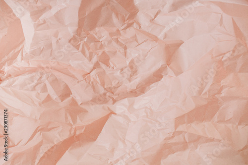 Fotografie Pastel peachy crumpled paper texture.