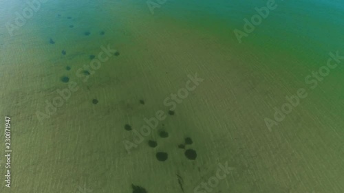 Flying over the sea. Aerial view of a green sea water, top view. photo