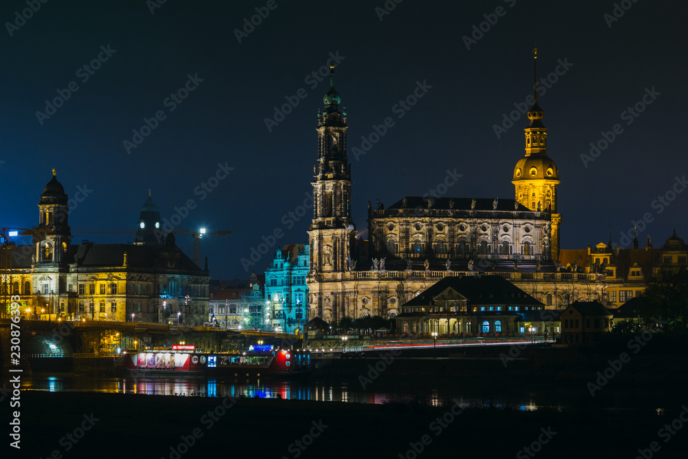 View of the old town of Dresden at night  with a view of water and the reflection of the city as well as, churches, towers and buildings. Elbe river. Germany. Saxony.