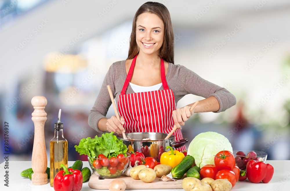 Young beautiful woman Cooking in kitchen Young beautiful woman Cooking in kitchen