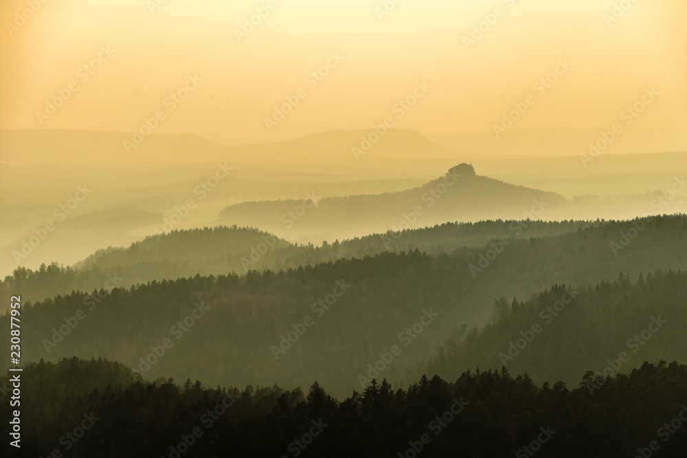 Saxon Switzerland mountains landscape layers in fog, Germany