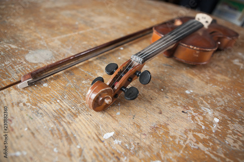 Violin and bow in vintage style on wood background photo