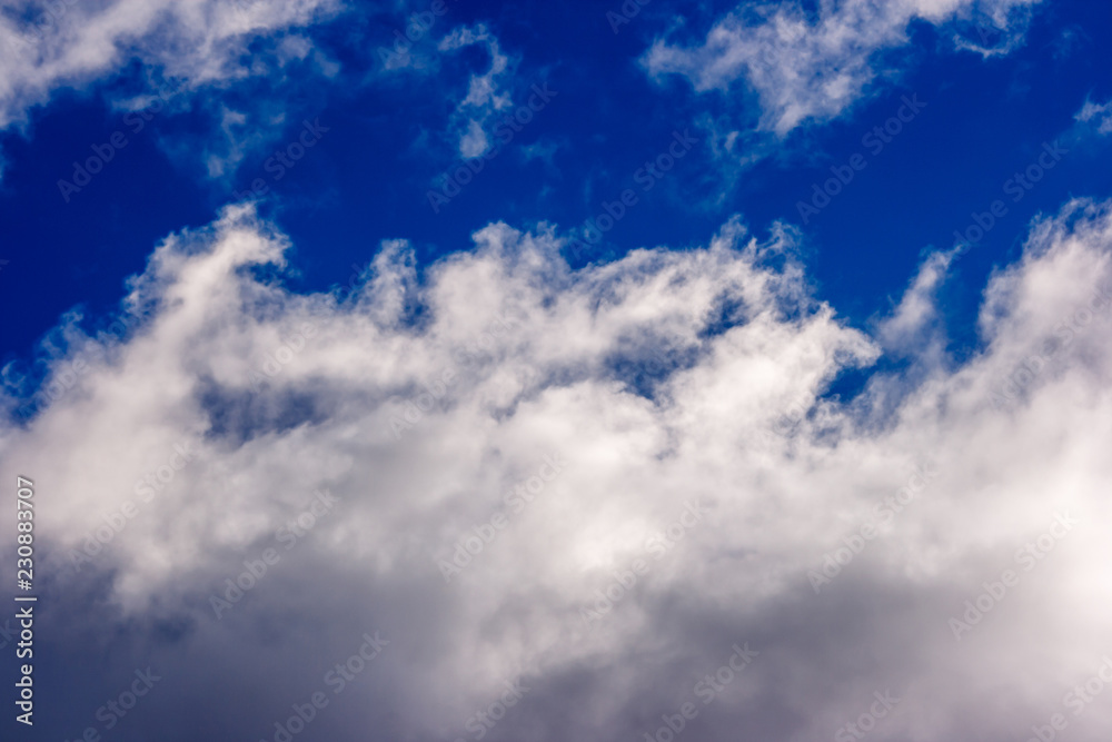 lush white cumulus clouds swim across the blue sky lush white cumulus clouds swim across the blue sky