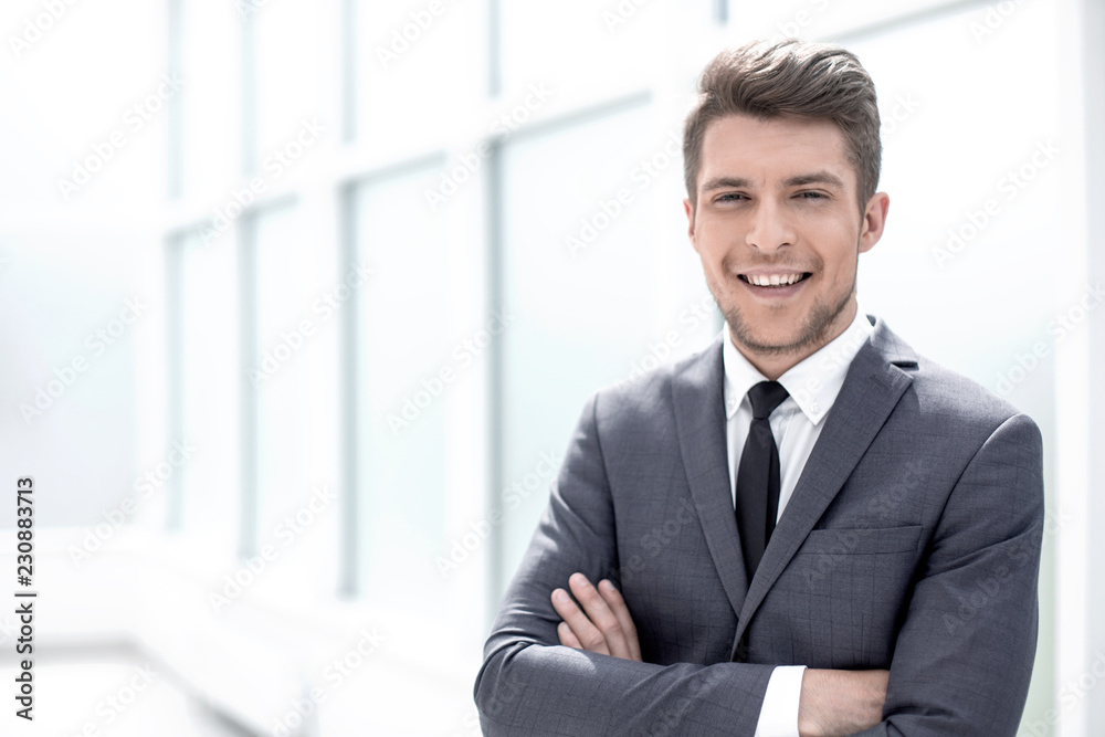 portrait of a businessman standing near the office window portrait of a businessman standing near the office window