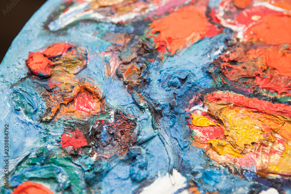 Background image of bright oil paint palette closeup
