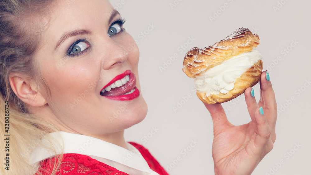 Happy woman holding choux puff cake Happy woman holding choux puff cake