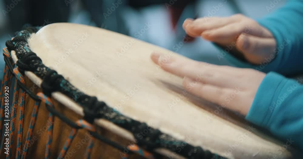 Close up of hands playing drum