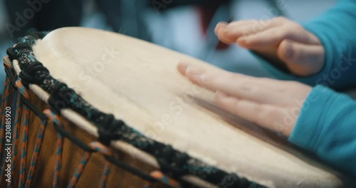 Close up of hands playing drum
