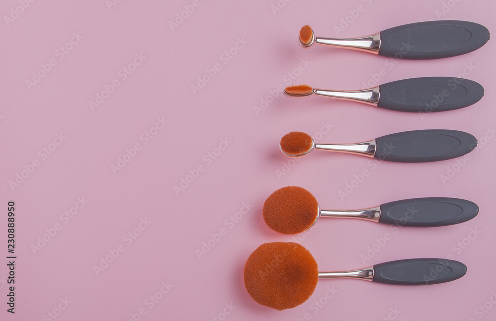 Set of oval brushes for makeup on pink background Set of oval brushes for makeup on pink background