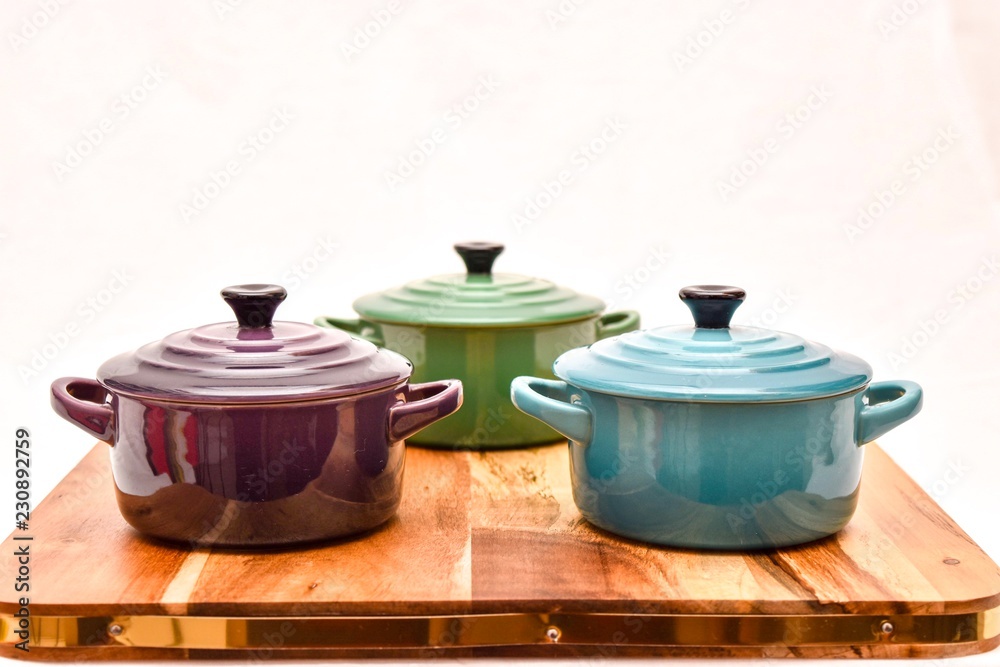 coloured cooking pots on a white background