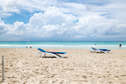 beach at the ocean on the background of beautiful clouds and the sun