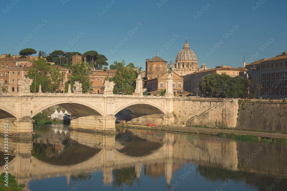 View of Vittorio Emanuele bridge on the Tiber river and St. Peter's Basilica in Vatican