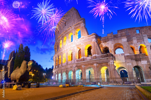 Canvas Print view of famous Colosseum illuminated at blue night in Rome with fireworks, Italy