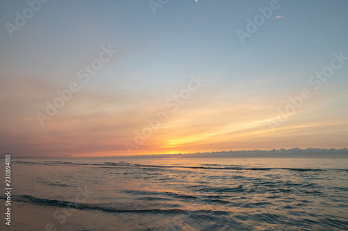 waves on the beach in the ocean at sunset