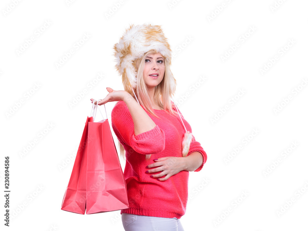 Woman in furry winter hat holding shopping bags Woman in furry winter hat holding shopping bags