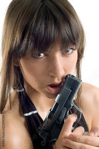 Beautiful girl with gun on white background is insulated