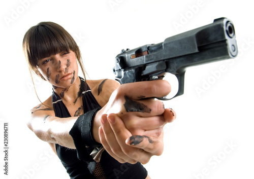 Beautiful girl with gun on white background is insulated