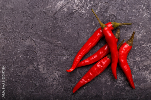 Red chili pepper on black stone