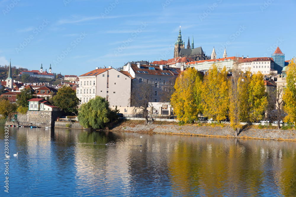 Fototapeta premium Colorful autumn Prague gothic Castle with the Lesser Town above River Vltava in the sunny Day, Czech Republic