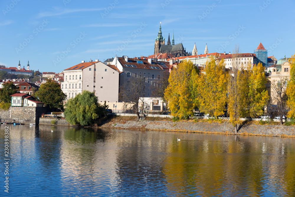 Colorful autumn Prague gothic Castle with the Lesser Town above River Vltava in the sunny Day, Czech Republic