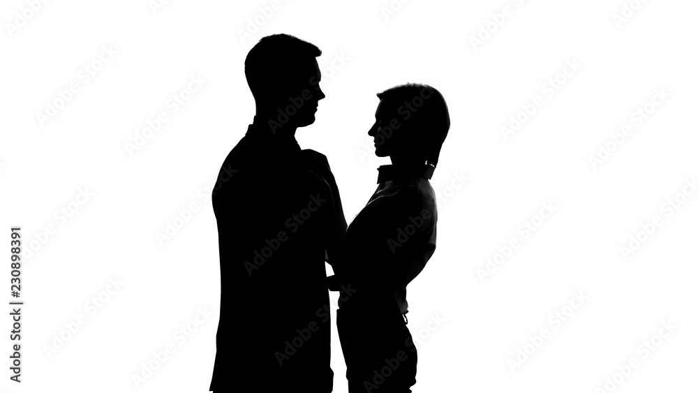 Silhouette of slim secretary tightly clinging to chest of her boss, romance