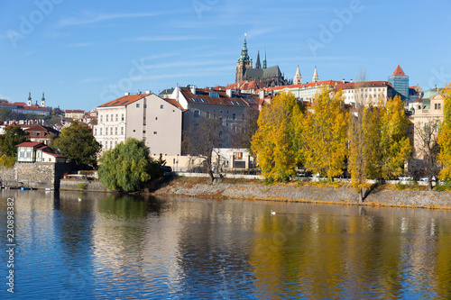 Fototapeta Naklejka Na Ścianę i Meble -  Colorful autumn Prague gothic Castle with the Lesser Town above River Vltava in the sunny Day, Czech Republic