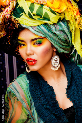 beauty bright woman with creative make up, many shawls on head l photo