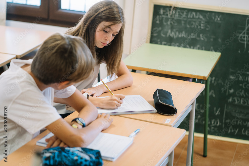 Fototapeta premium Couple young students studying at school